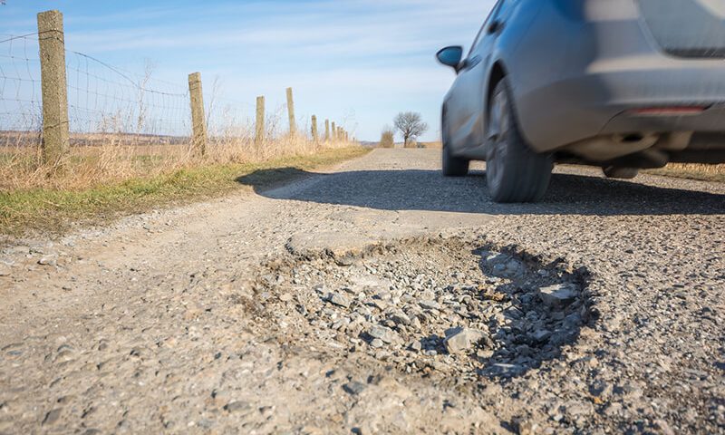 Drivers are swerving onto the wrong side of the road to avoid the danger of hitting a pothole