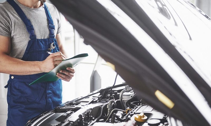 Mechanic carrying out a car service.