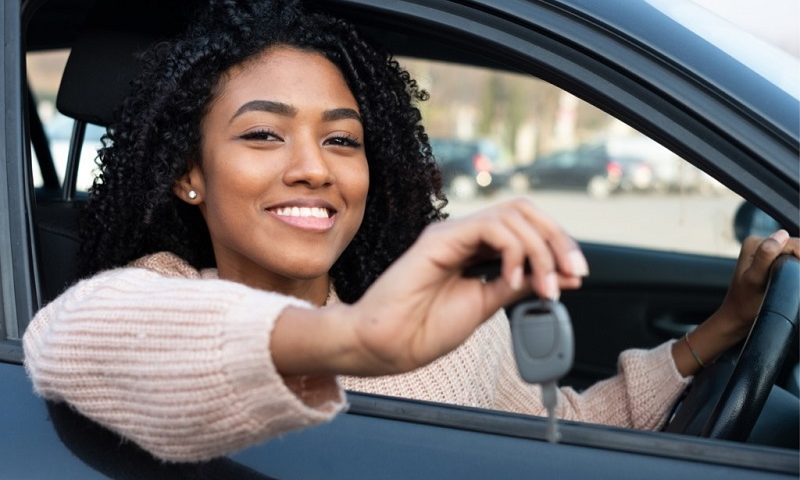 New driver holding car key.