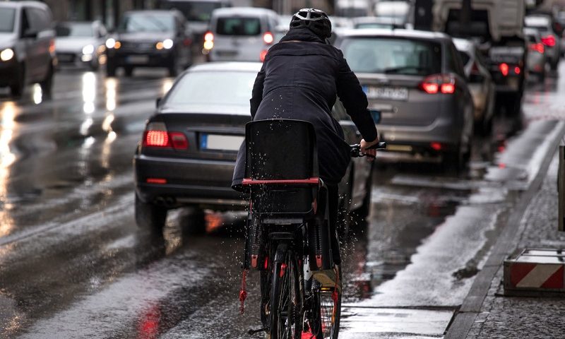 Cyclist on rainy street.