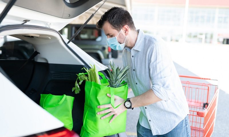 Man loading car with groceries