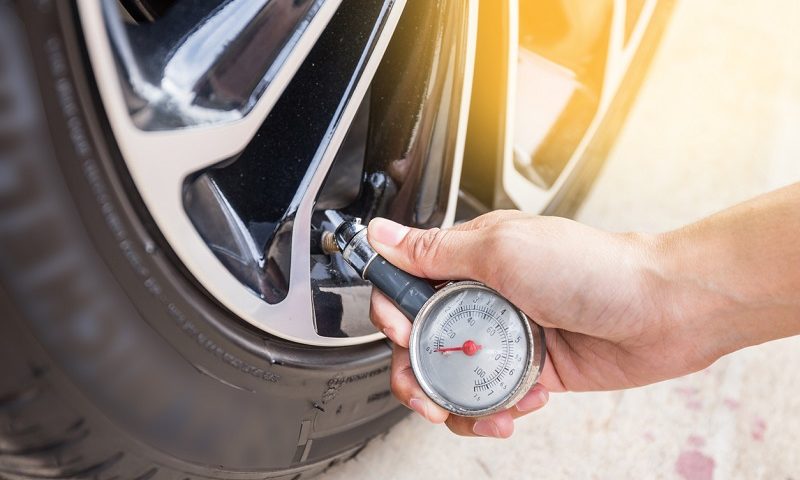 A man checking tyre pressure