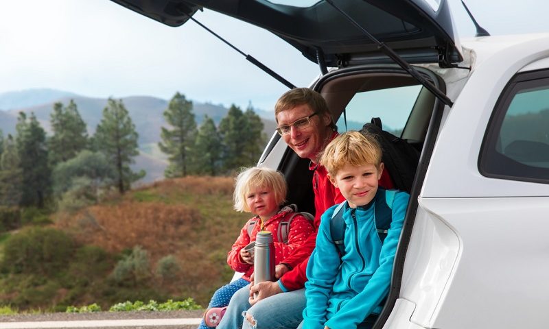 Father with kids on driving trip