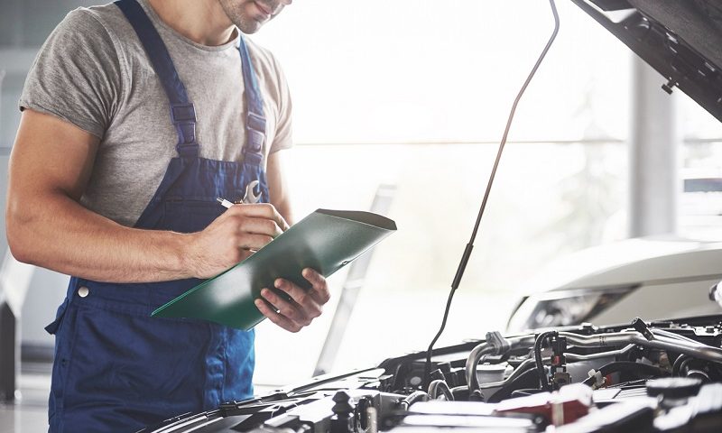 Mechanic in a garage checking a car