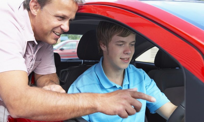 A teenage boy learning how to drive