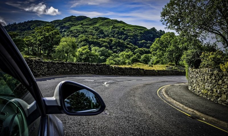 Car on sunny road in Lake District