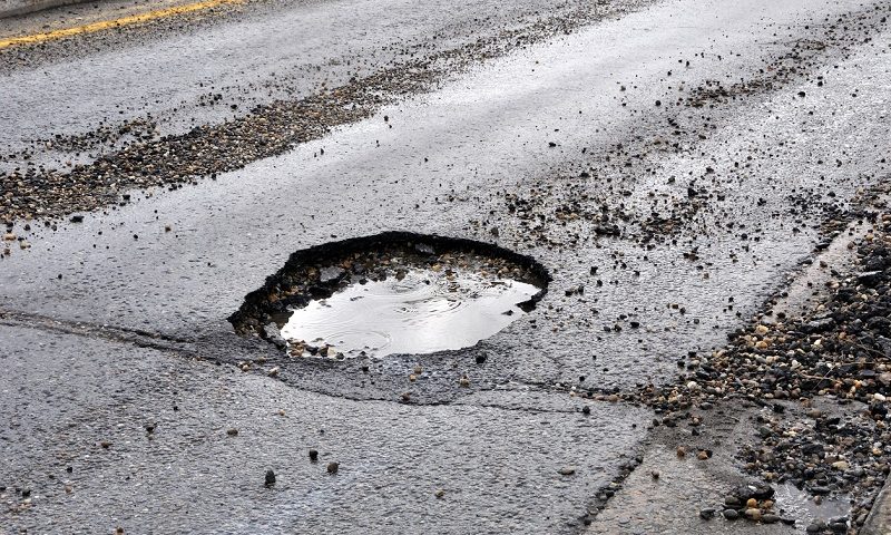 Pothole damaged road