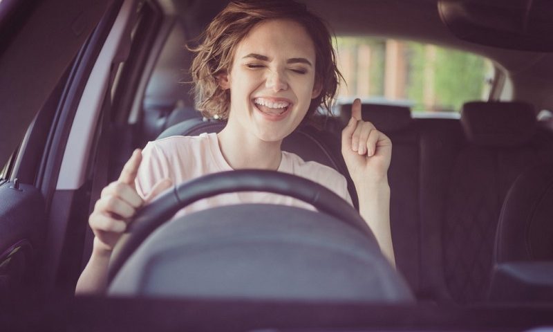 Woman singing in a car