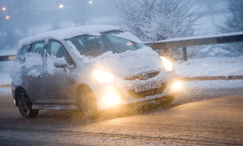 Car using fog lights in snowy weather