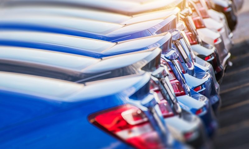 Line of new cars at an automotive factory