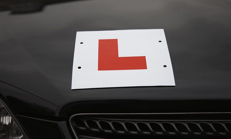 L-plate attached to car bonnet