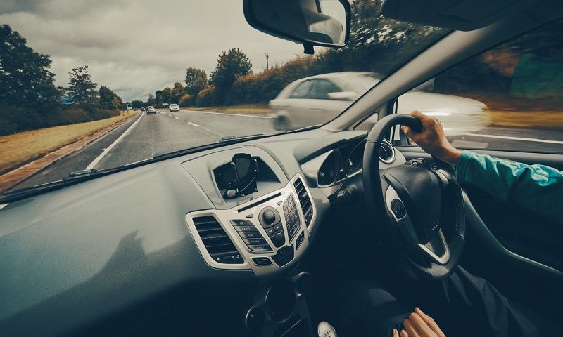 Person behind the wheel of a car