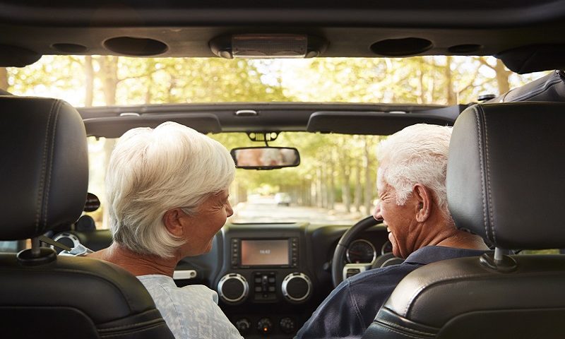 An older couple enjoying a drive