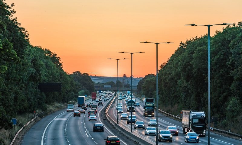 Cars driving on the motorway during sunset.