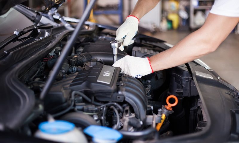 Car mechanic working on a car.