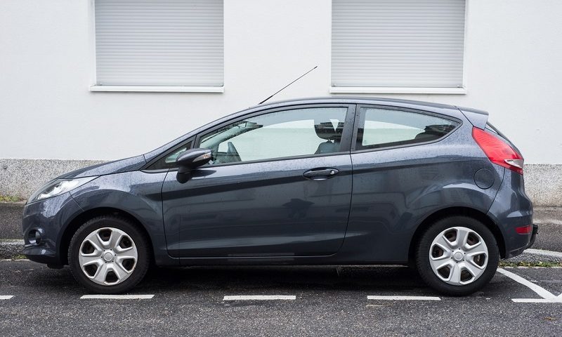 Grey Ford Fiesta parked outside in front of a building